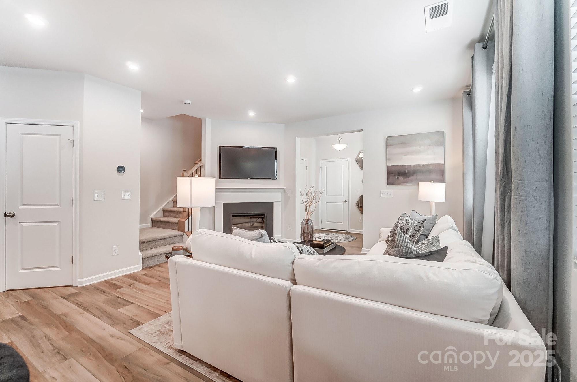 311 Laura Elizabeth Lane Clover, SC 29710 - Photo 6 of 39 a living room with furniture a fireplace and a flat screen tv