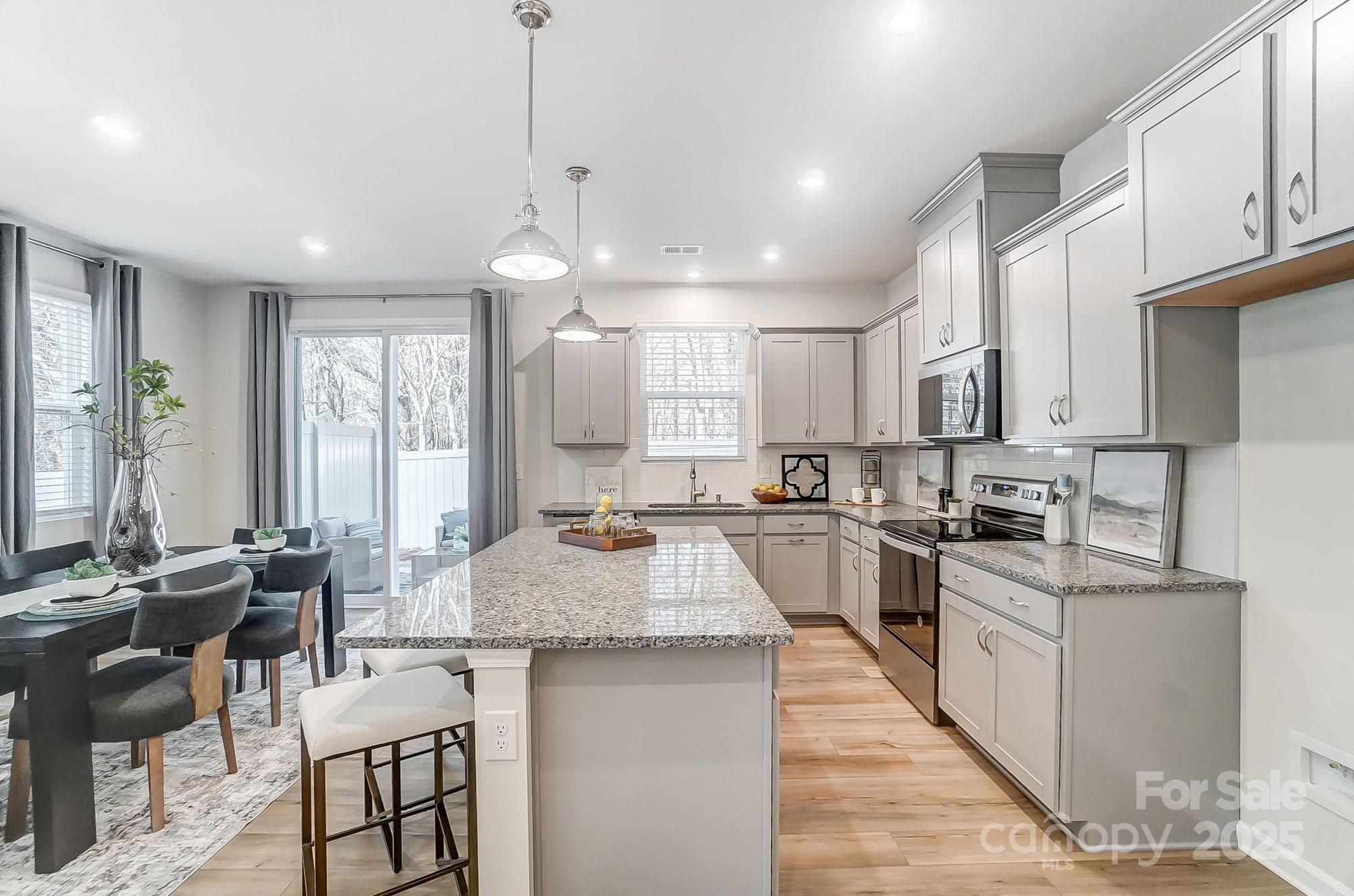 311 Laura Elizabeth Lane Clover, SC 29710 - Photo 8 of 39 a large kitchen with lots of counter space a sink and chairs