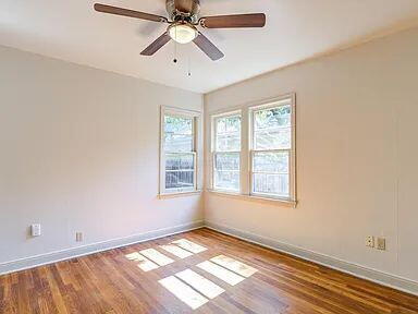 2716 29th Street Lubbock, TX 79410 - Photo 17 of 27 a view of an empty room with wooden floor and a window