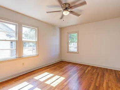2716 29th Street Lubbock, TX 79410 - Photo 18 of 27 a view of an empty room with wooden floor and a window