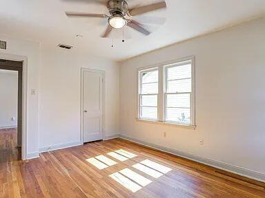 2716 29th Street Lubbock, TX 79410 - Photo 21 of 27 a view of an empty room with wooden floor and a window