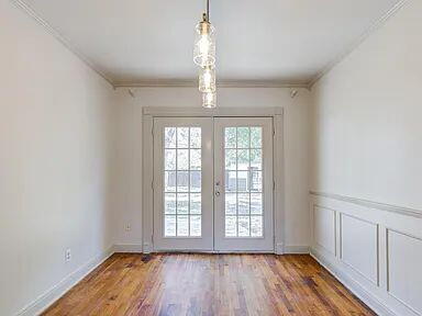 2716 29th Street Lubbock, TX 79410 - Photo 10 of 27 a view of an empty room with wooden floor and a window