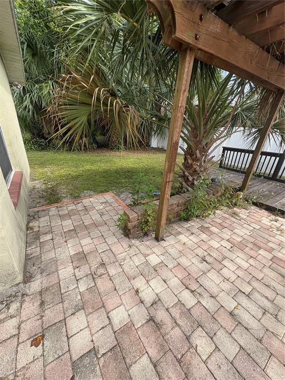 26 Prosperity Lane, Unit A Palm Coast, FL 32164 - Photo 15 of 15 a view of a yard with plants and wooden fence