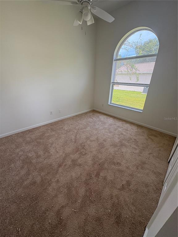 26 Prosperity Lane, Unit A Palm Coast, FL 32164 - Photo 9 of 15 an empty room with windows and closet