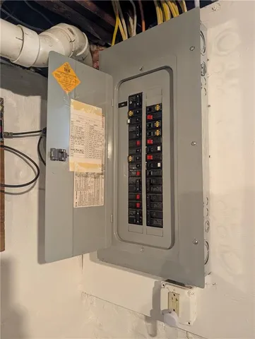 a view of water heater room with wooden walls