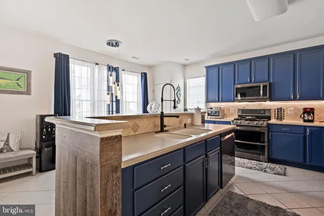 a kitchen with a table chairs microwave and refrigerator