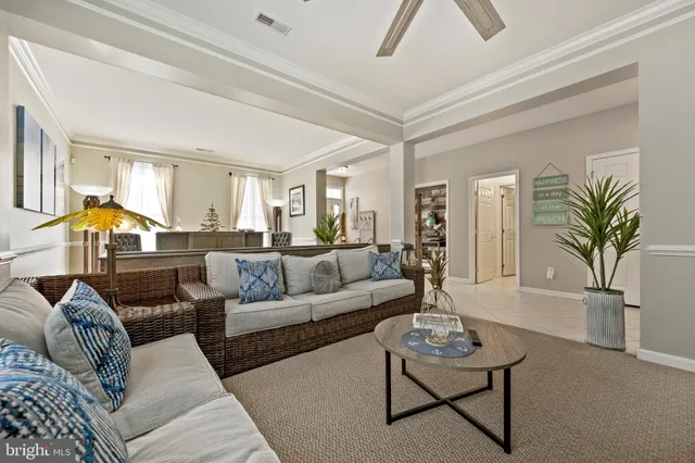 a living room with furniture and a entryway