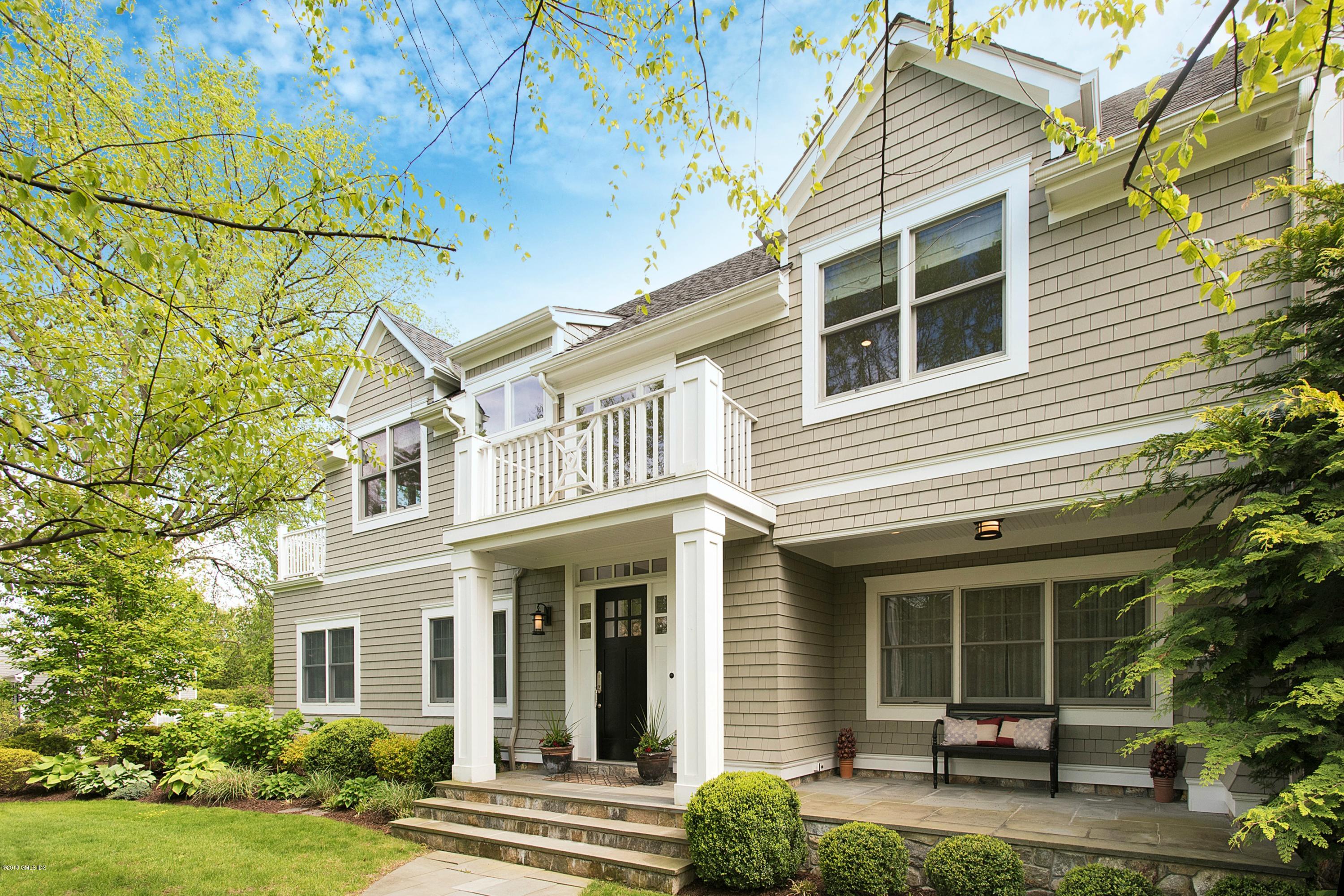 a view of a white house next to a yard