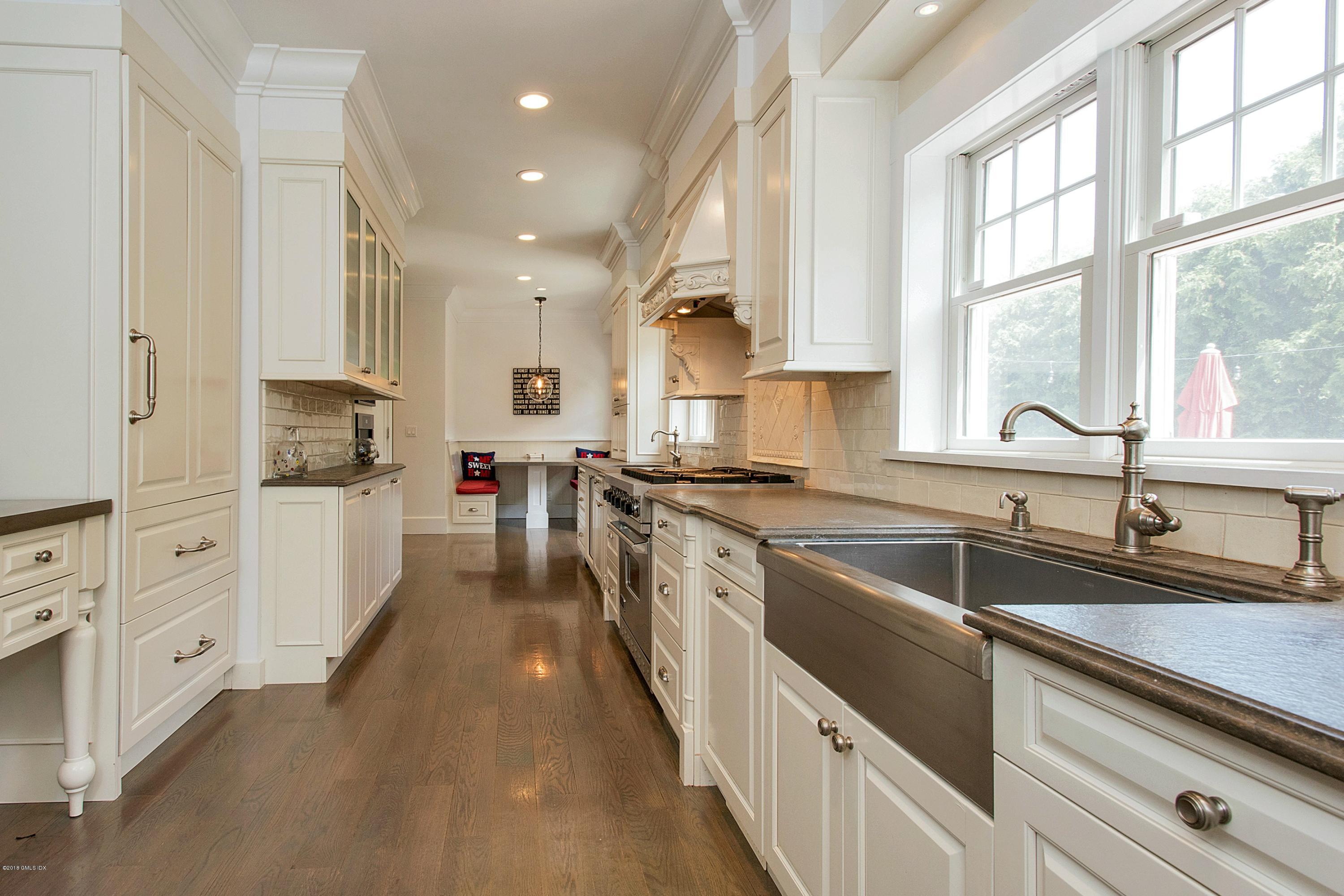 246 Riverside Avenue Riverside, CT 06878 - Photo 11 of 36 a kitchen with white cabinets and white appliances