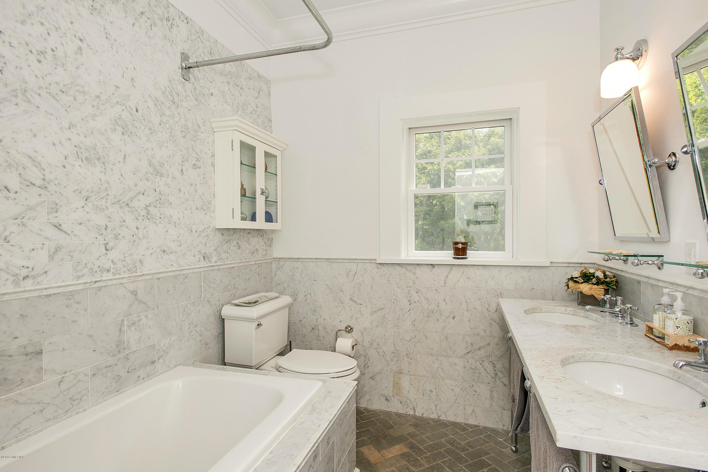 246 Riverside Avenue Riverside, CT 06878 - Photo 16 of 36 a bathroom with a tub a sink and a window