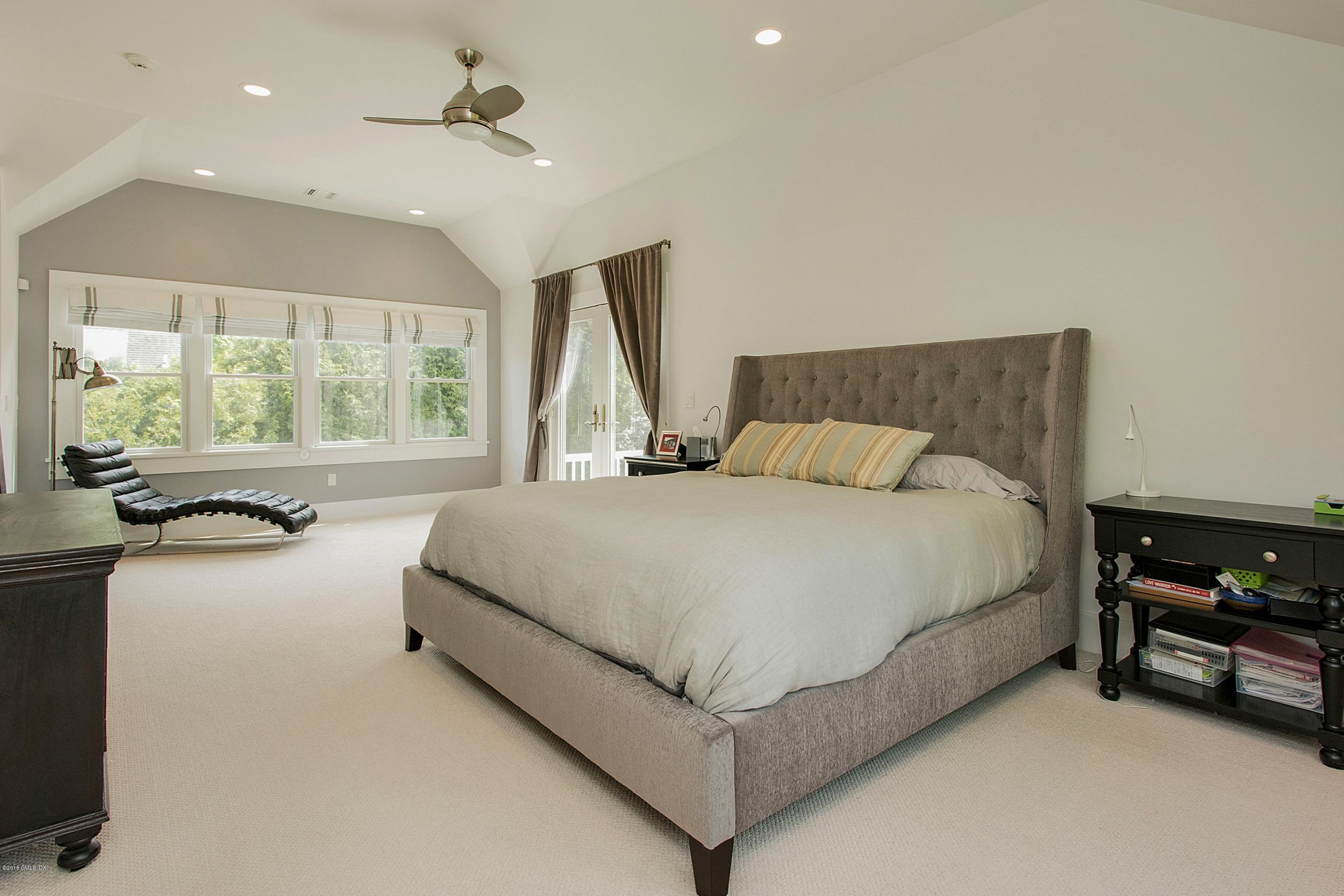 246 Riverside Avenue Riverside, CT 06878 - Photo 17 of 36 a bedroom with a bed and a large window