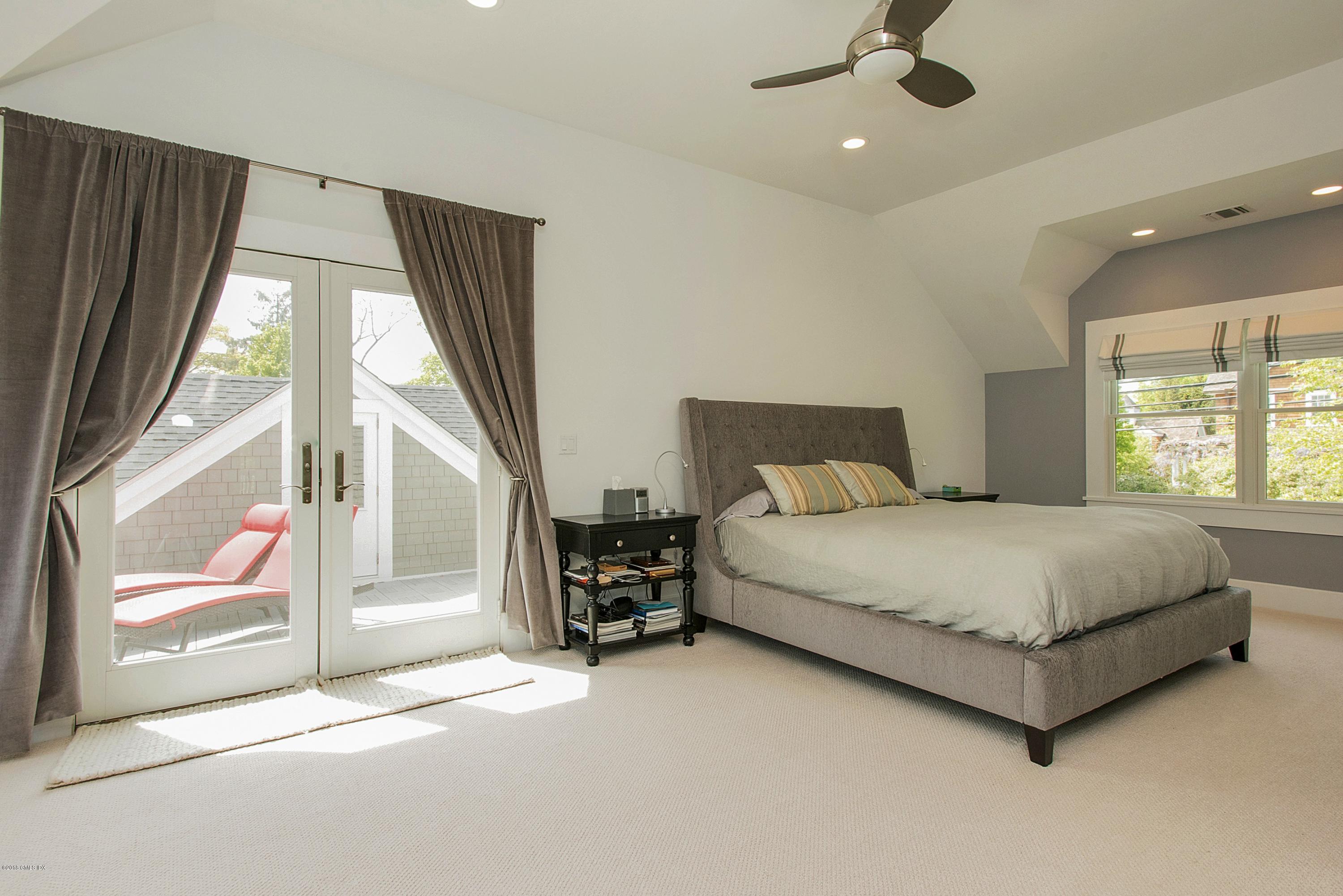 246 Riverside Avenue Riverside, CT 06878 - Photo 18 of 36 a spacious bedroom with a large bed and a window