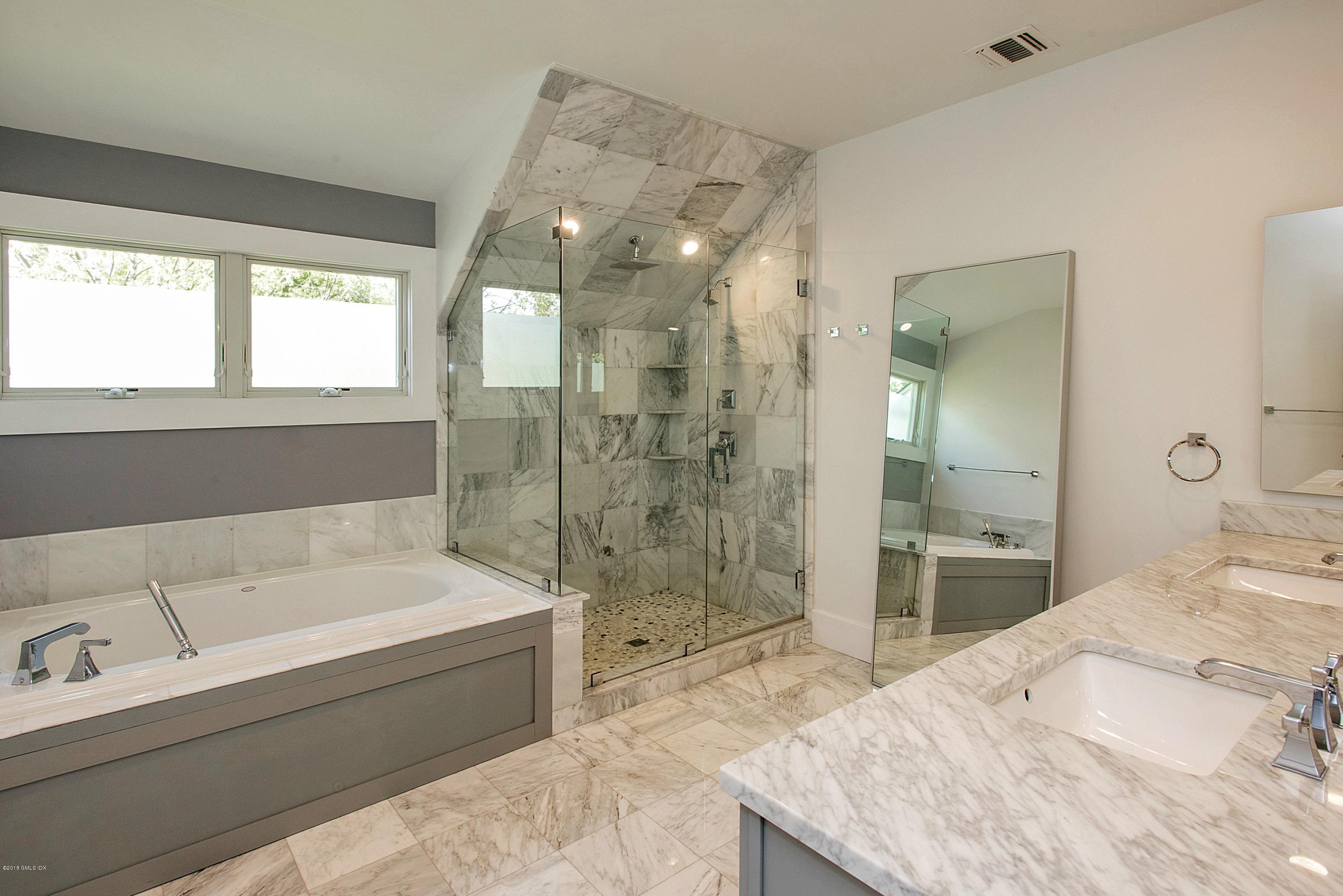 246 Riverside Avenue Riverside, CT 06878 - Photo 20 of 36 a spacious bathroom with a tub sink shower and a mirror