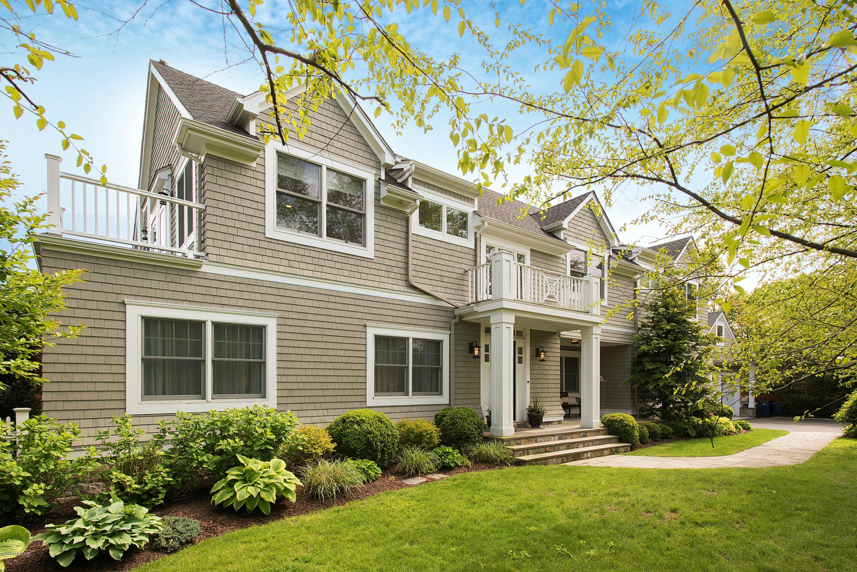 246 Riverside Avenue Riverside, CT 06878 - Photo 2 of 36 a front view of a house with a yard and potted plants
