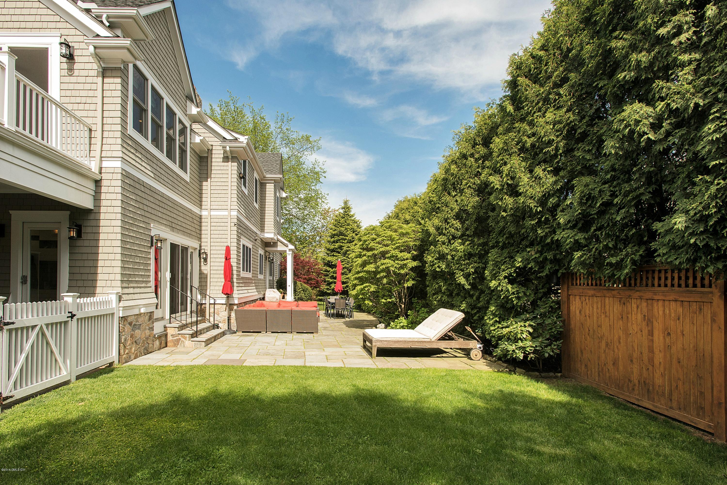 246 Riverside Avenue Riverside, CT 06878 - Photo 29 of 36 a view of a chair and tables in the back yard of the house