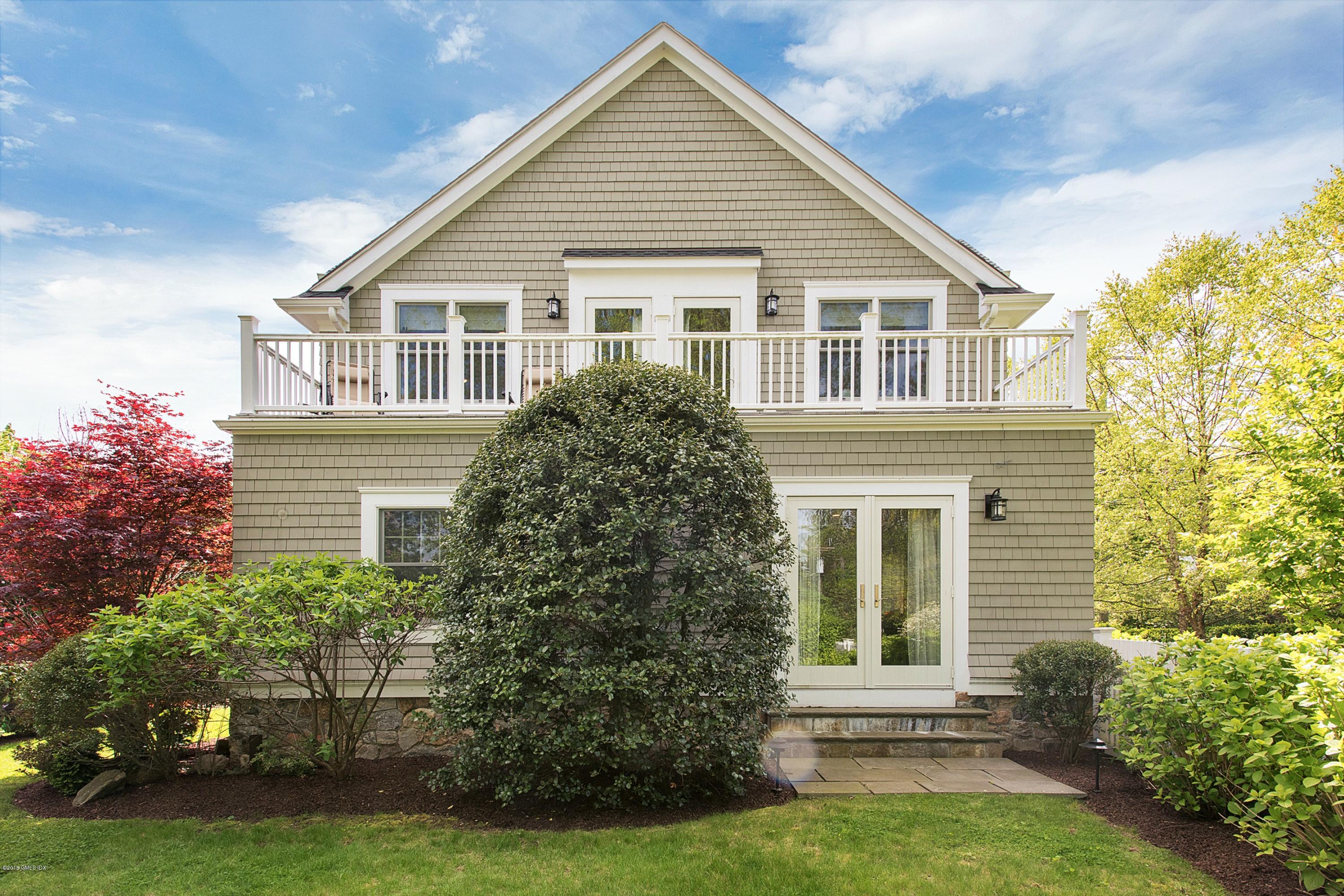 246 Riverside Avenue Riverside, CT 06878 - Photo 30 of 36 a front view of a house with a garden