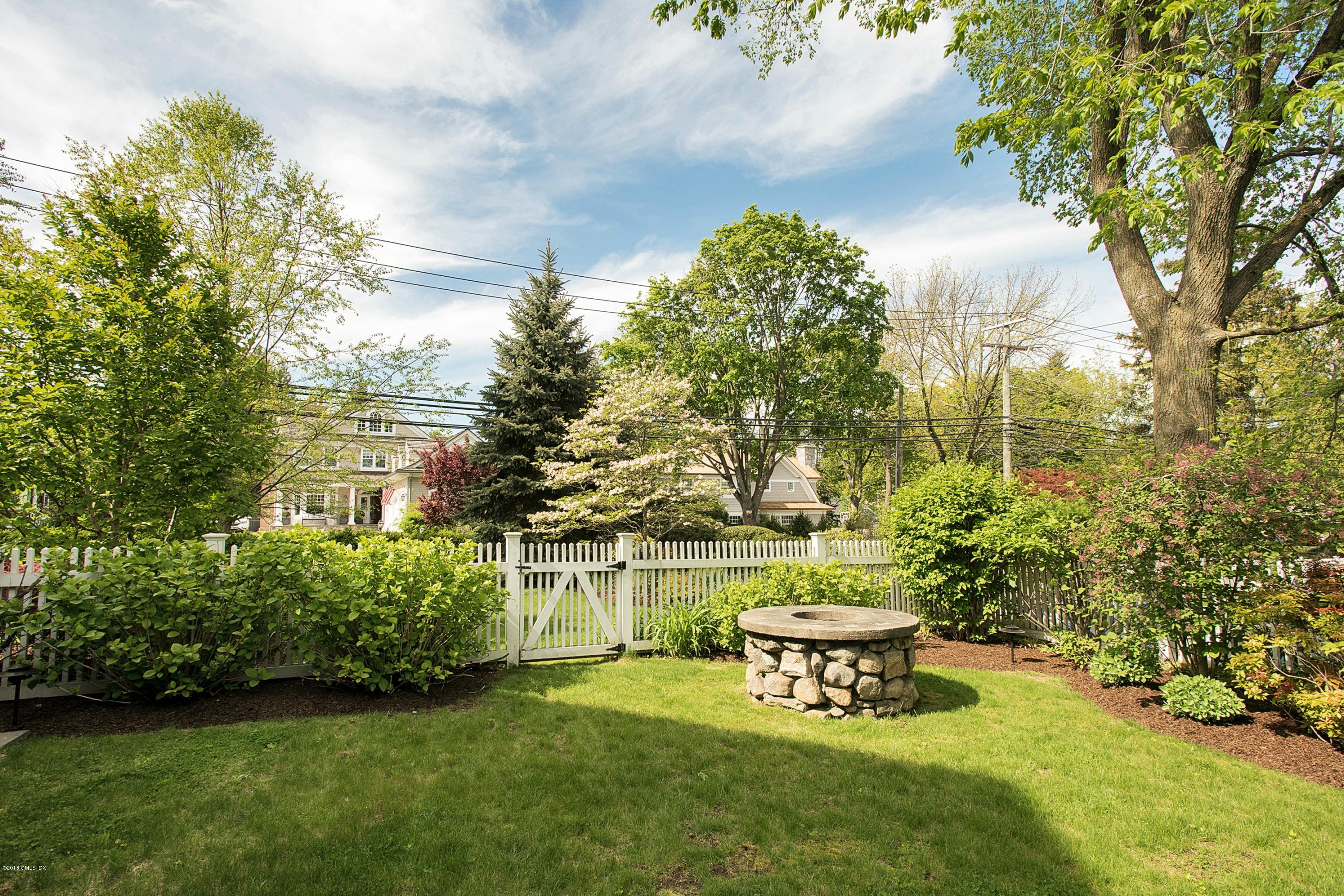 246 Riverside Avenue Riverside, CT 06878 - Photo 32 of 36 a view of a bench in the garden near a lake