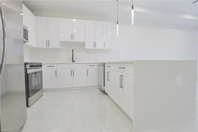 a kitchen with white cabinets