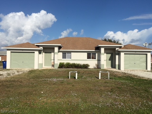 789 Alabama Road South Lehigh Acres, FL 33974 - Photo 1 of 30 front view of a house with a yard