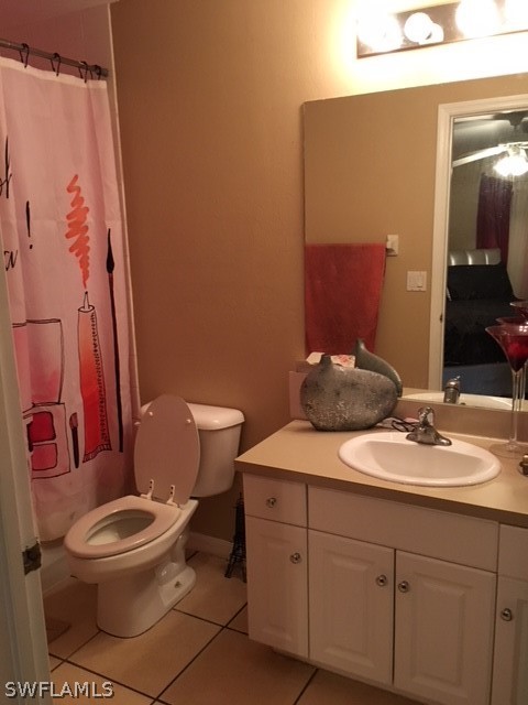 789 Alabama Road South Lehigh Acres, FL 33974 - Photo 14 of 30 a bathroom with a toilet a sink and mirror