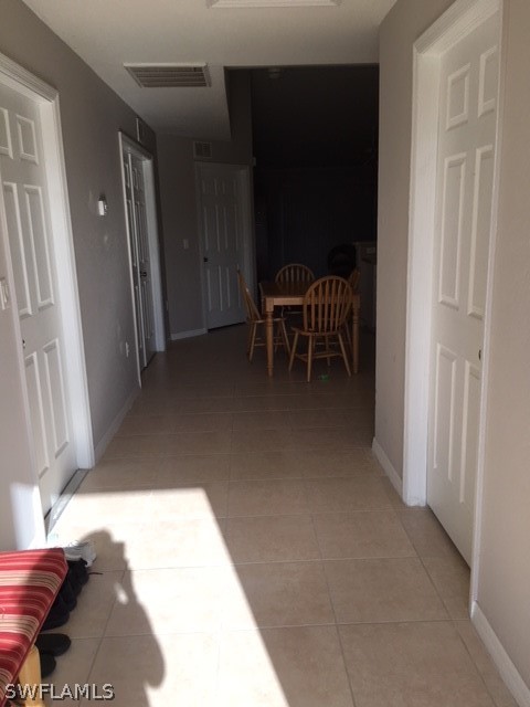 789 Alabama Road South Lehigh Acres, FL 33974 - Photo 2 of 30 a view of a bedroom with furniture and staircase
