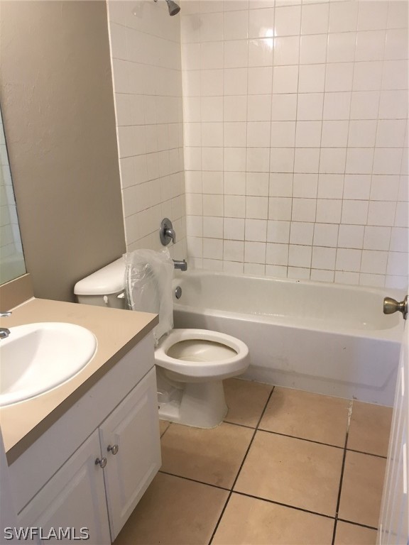 789 Alabama Road South Lehigh Acres, FL 33974 - Photo 23 of 30 a bathroom with a granite countertop bathtub sink vanity mirror and toilet