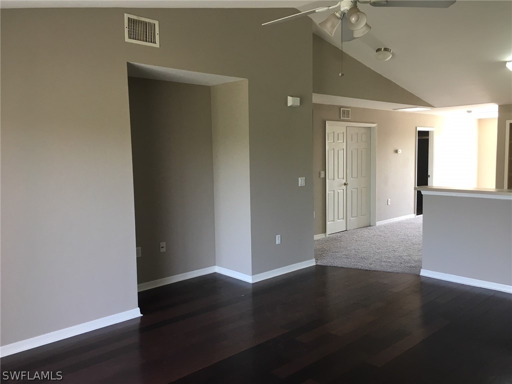 789 Alabama Road South Lehigh Acres, FL 33974 - Photo 28 of 30 an empty room with wooden floor and windows
