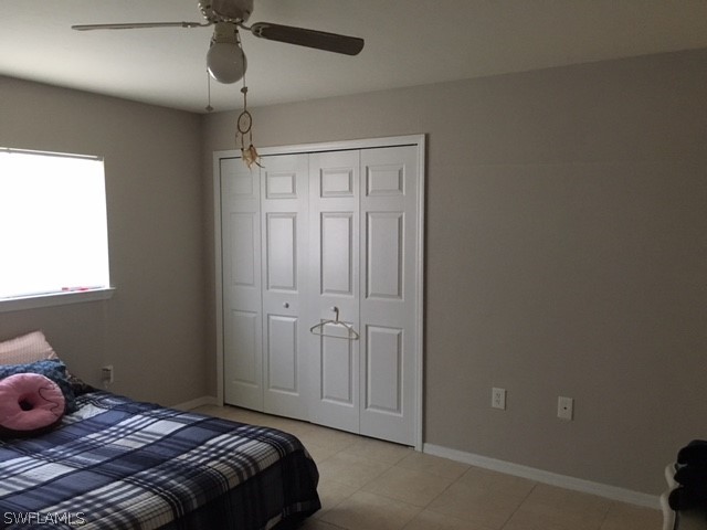 789 Alabama Road South Lehigh Acres, FL 33974 - Photo 8 of 30 a bedroom with a bed and a window