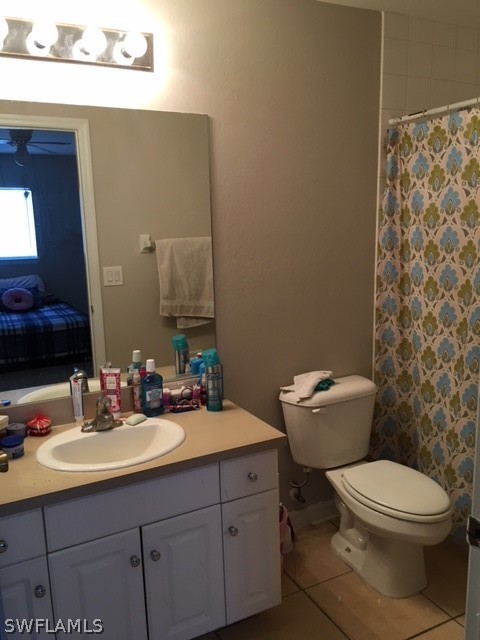 789 Alabama Road South Lehigh Acres, FL 33974 - Photo 9 of 30 a bathroom with a toilet a sink and mirror