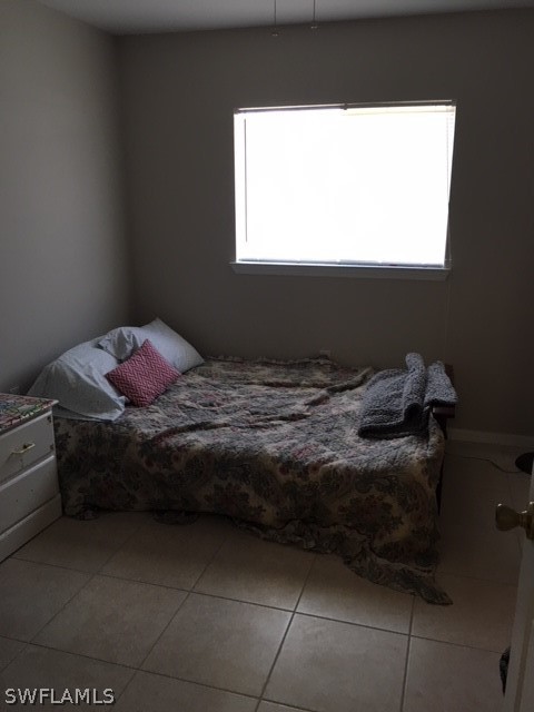 789 Alabama Road South Lehigh Acres, FL 33974 - Photo 10 of 30 a bedroom with a bed and a window