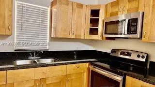 a kitchen that has a sink and a stove