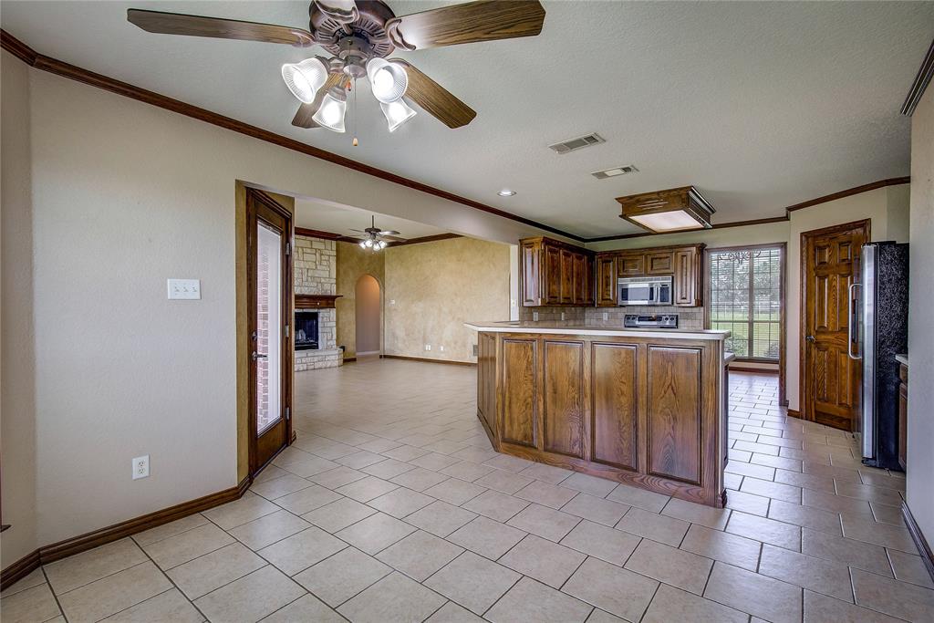 10000 County Road 357 Terrell, TX 75161 - Photo 13 of 38 a kitchen with stainless steel appliances granite countertop a refrigerator and a sink