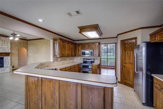a kitchen with stainless steel appliances granite countertop a stove and a refrigerator