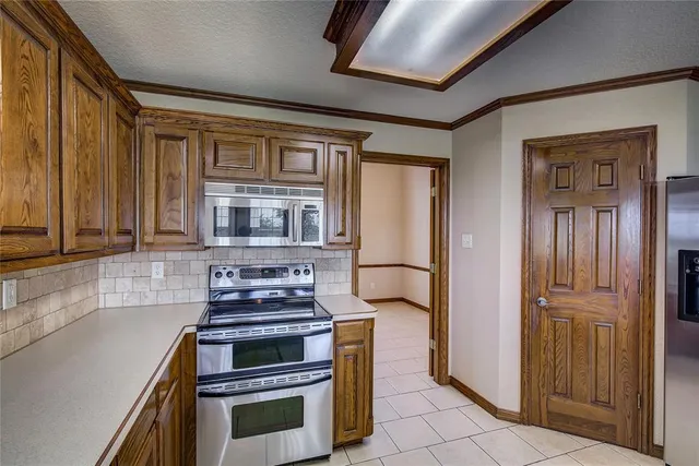 a view of a backyard with wooden floor and fence