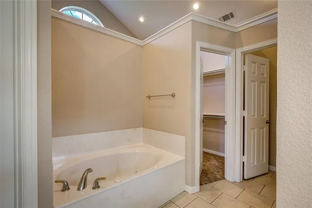 a bathroom with a glass shower door and a shower