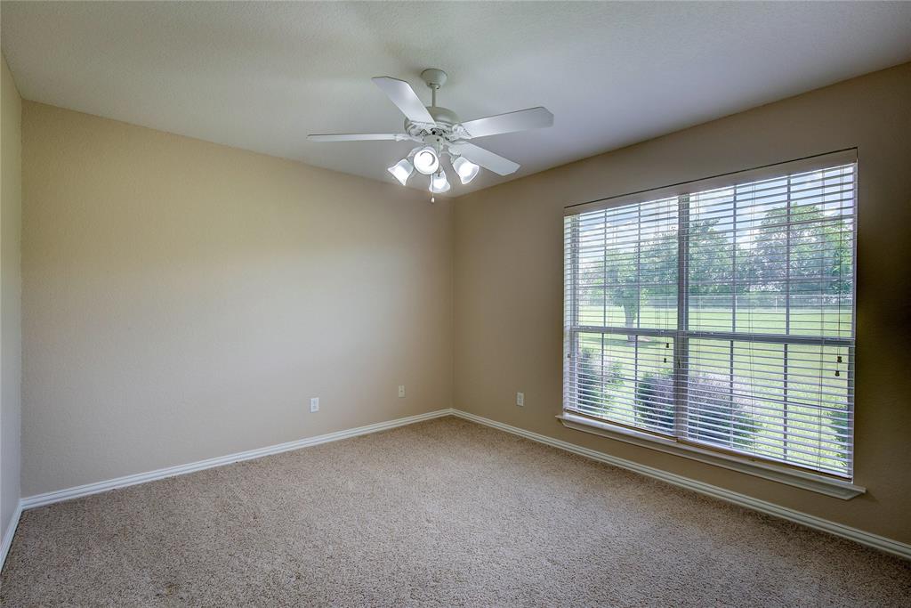 10000 County Road 357 Terrell, TX 75161 - Photo 25 of 38 a view of an empty room with chandelier fan and fire place