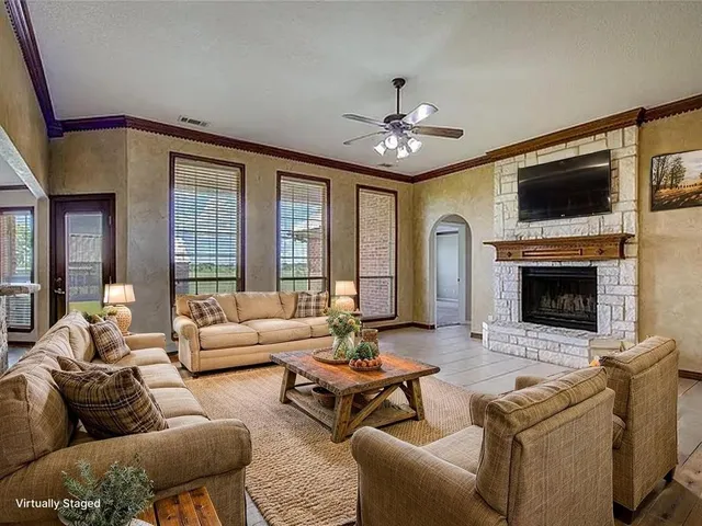 a view of an empty room with a fireplace and a window