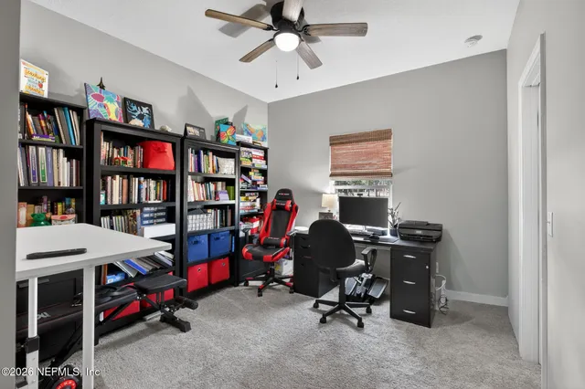 a bedroom with a bed and a refrigerator