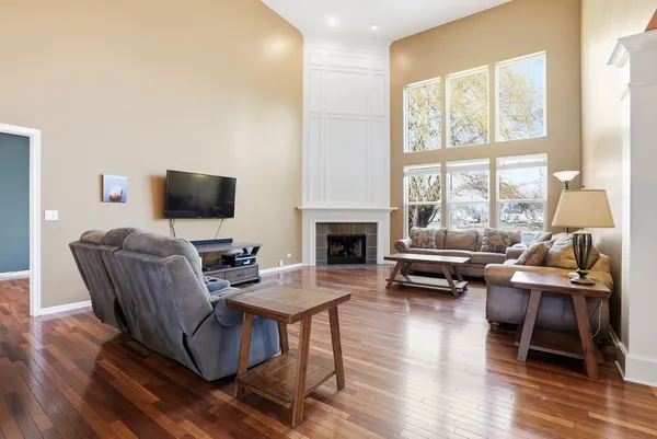 a living room with furniture a fireplace and a flat screen tv
