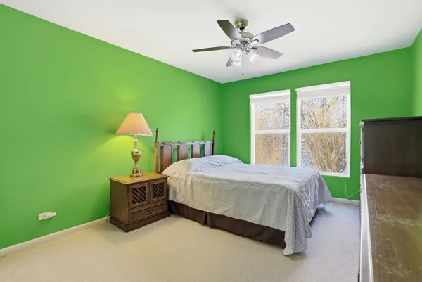 a bed room with a bed and a chandelier