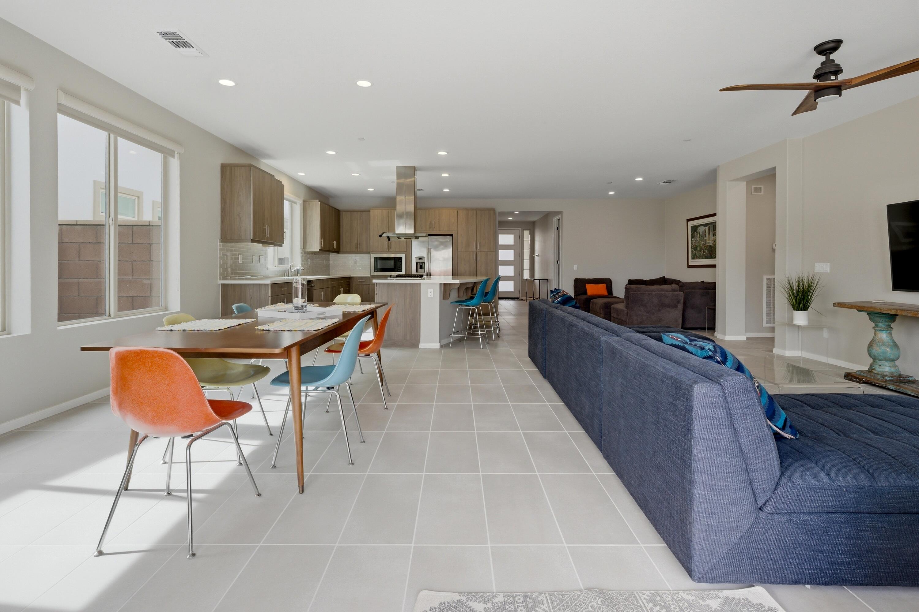 51370 North Two Palms Way Indio, CA 92201 - Photo 1 of 37 a living room with stainless steel appliances kitchen island granite countertop lots of white furniture a window and a chandelier