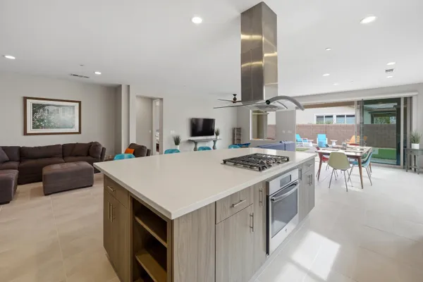 a kitchen with a stove a table and chairs