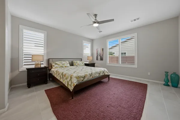 a bedroom with a large bed and a chandelier