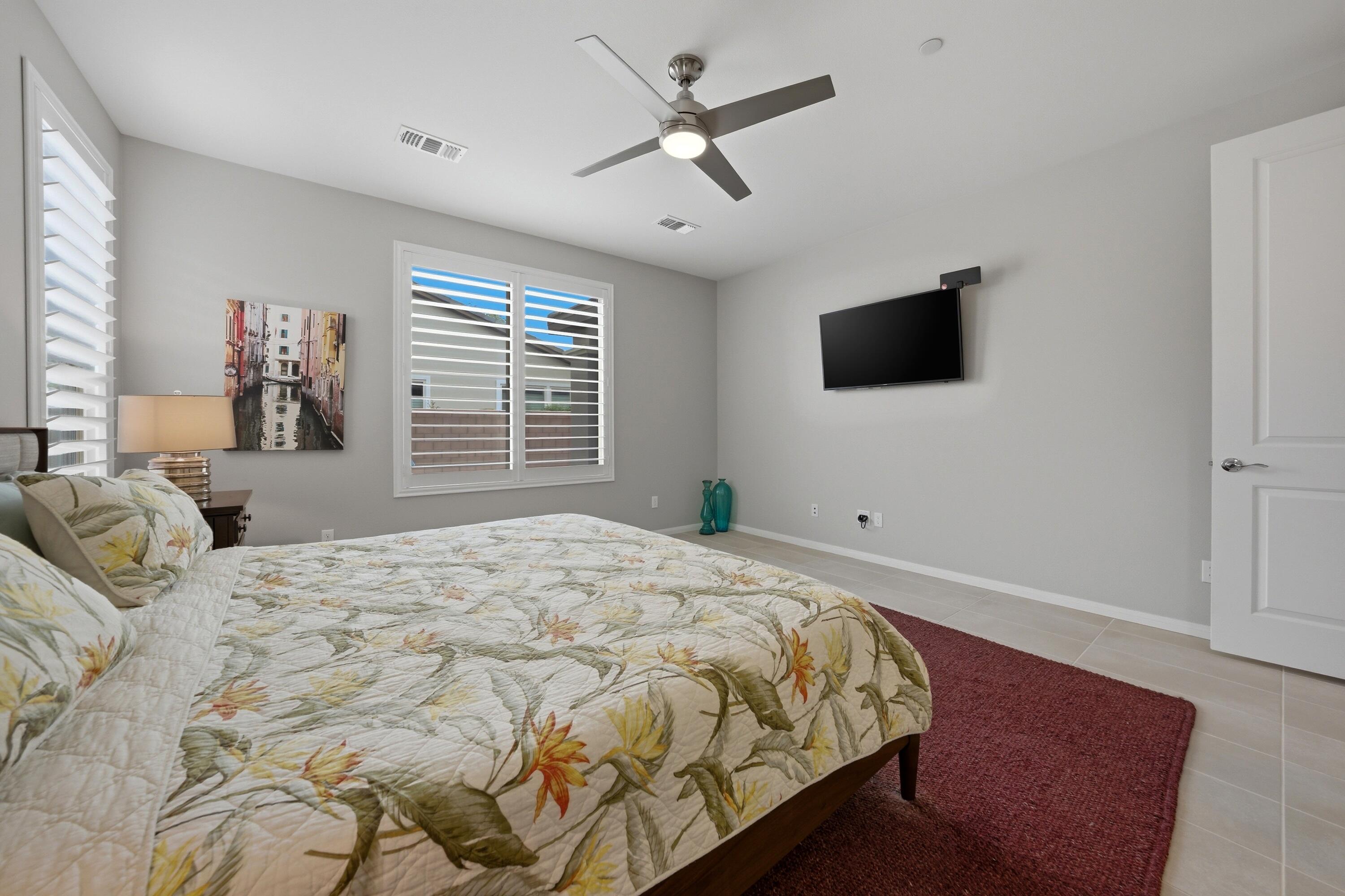 51370 North Two Palms Way Indio, CA 92201 - Photo 14 of 37 a bedroom with a large bed and a flat screen tv