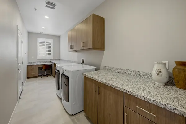 a utility room with sink dryer and washer