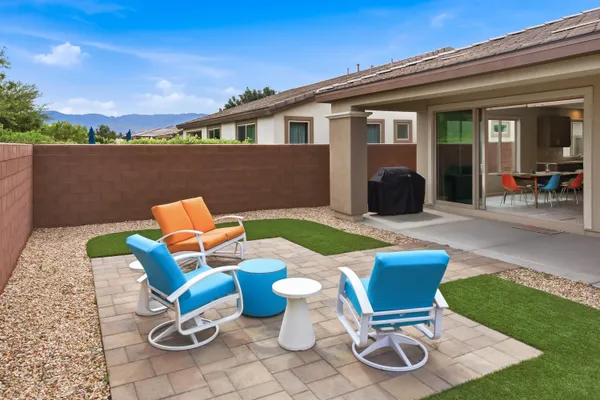 a view of a backyard with furniture and a garden