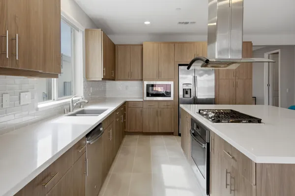 a kitchen with stainless steel appliances a sink stove and cabinets