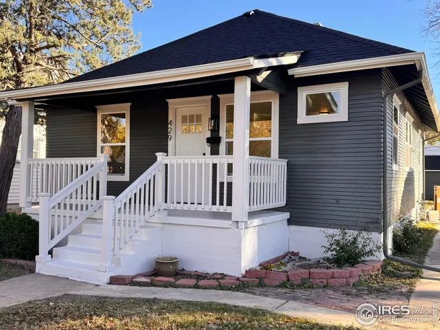 a view of a house with wooden fence