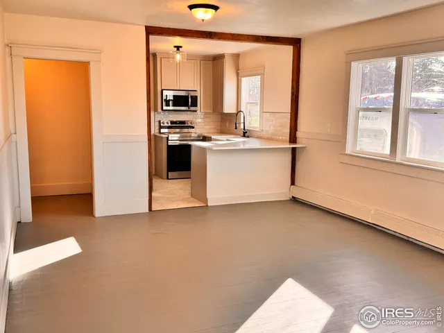 a kitchen with stainless steel appliances a refrigerator and a stove top oven