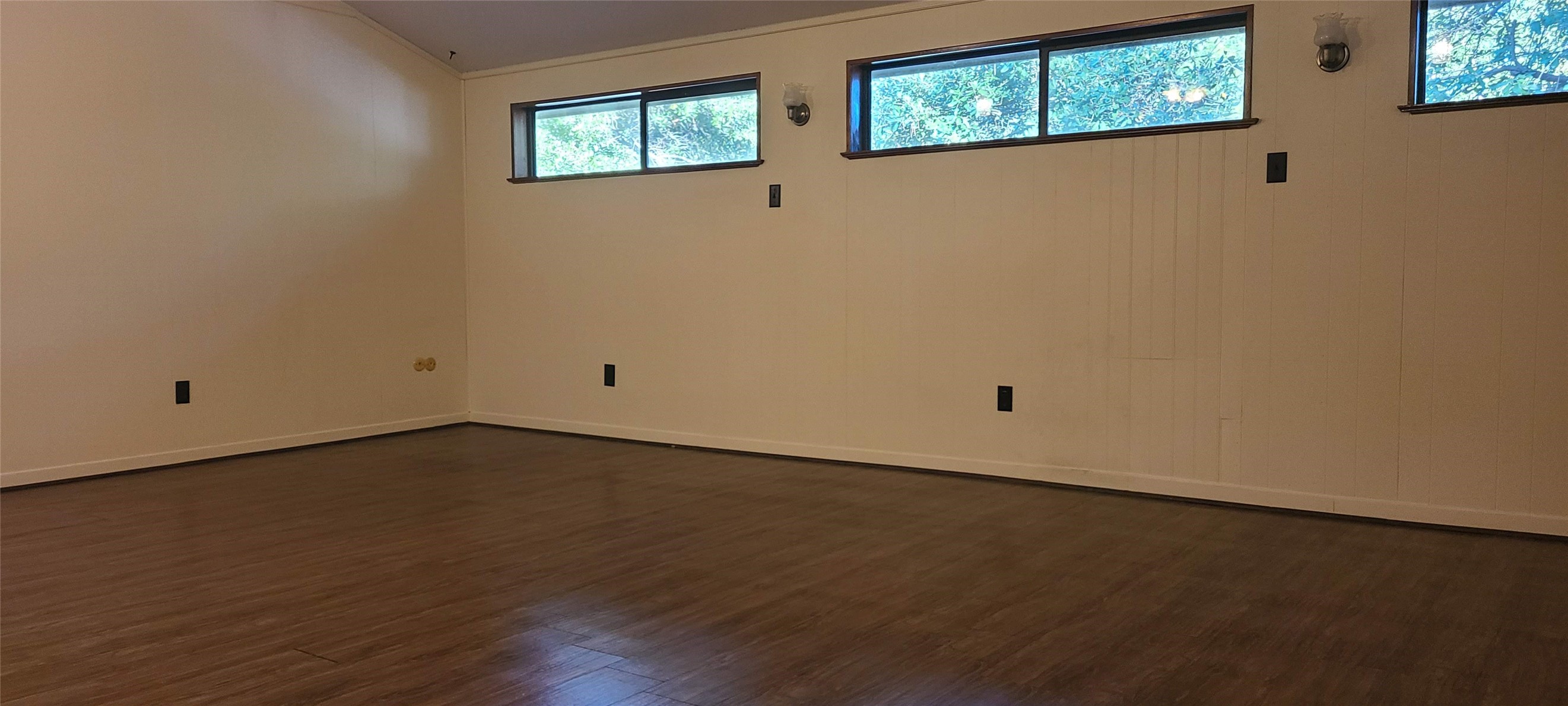 2604 Bois D Arc Drive Huntsville, TX 77320 - Photo 3 of 12 a view of an empty room with wooden floor and windows